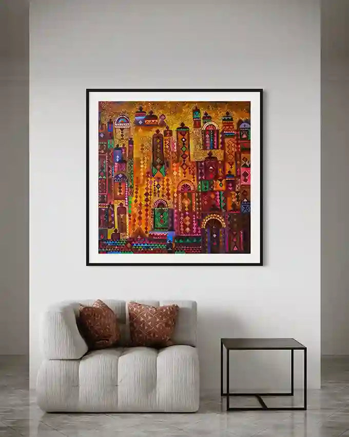 Framed Nubian Doors 2 artwork in gold and jewel tones displayed above gray sofa with patterned cushions and side table
