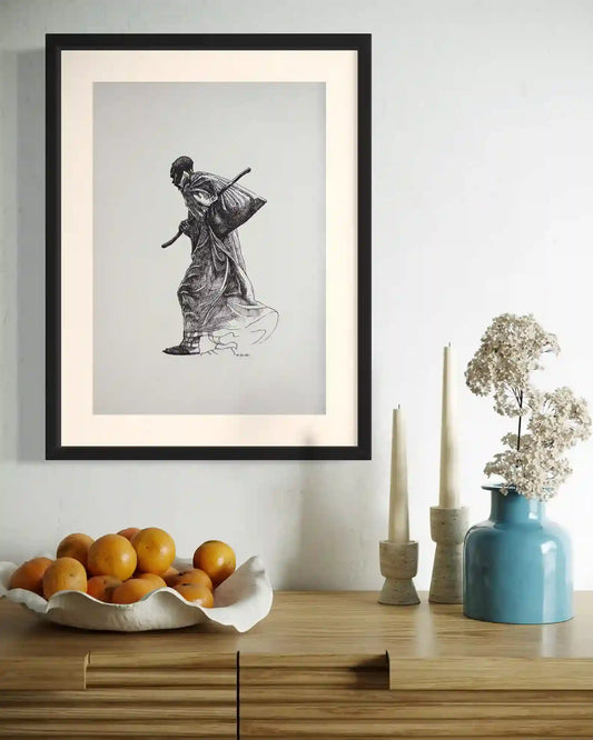 The Unseen framed original artwork by Obada Gabir displayed above wood sideboard with oranges candles and blue vase decor
