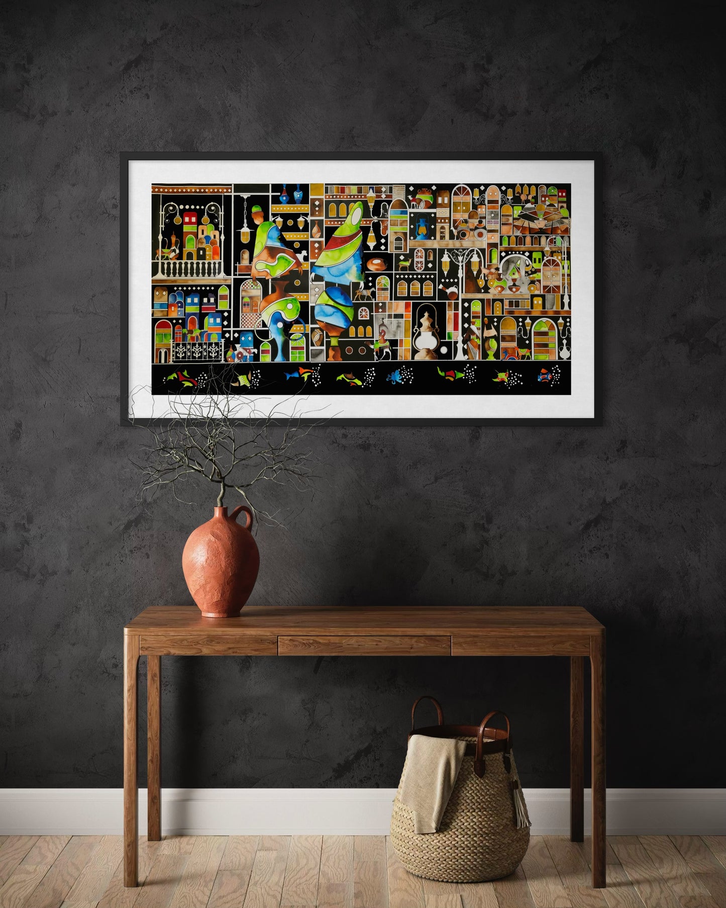 Framed artwork on a dark wall above a wooden console table.