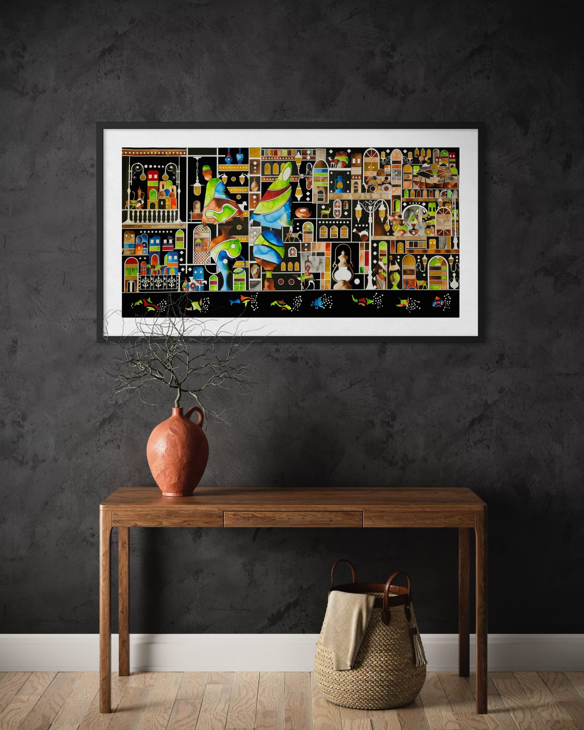 Framed artwork on a dark wall above a wooden console table.