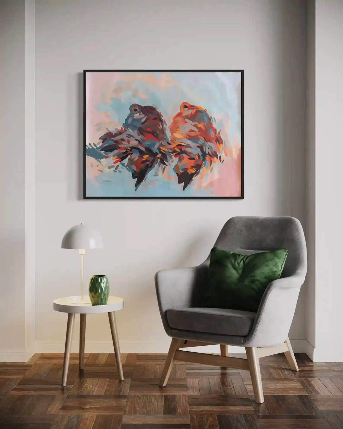 Daughters of the Nile by Khalid Yan framed art print displayed above gray chair with green pillow in modern living room